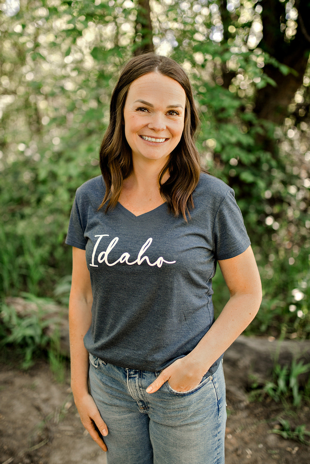 This Idaho V neck is your perfect summer tee. It is a triblend and such a soft and light weight material. This Idaho T shirt has the word Idaho no it, in a elegant and simple design. The Idaho is in cursive. The color of this tee shirt is navy. It is a beautiful heather navy that goes well with any outfit.