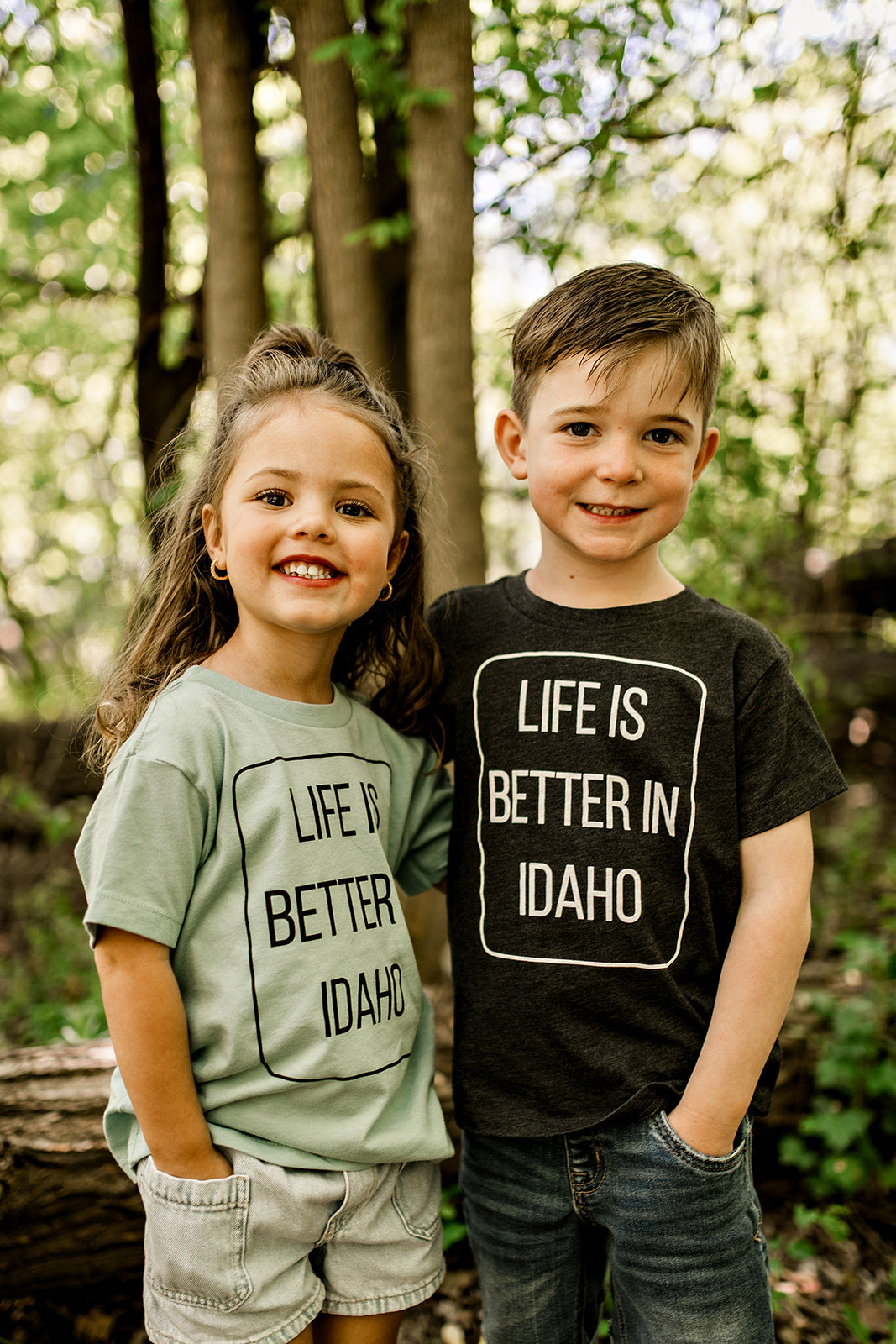 Two Idaho kids standing together wearing Idaho T shirts that says Life is Better in Idaho
