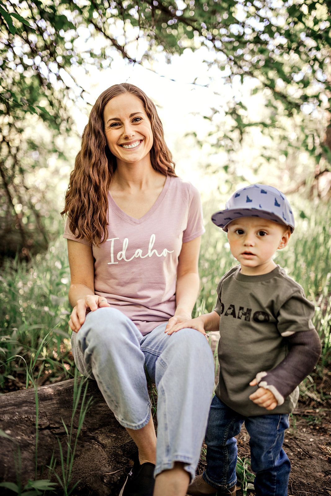 A young mom sitting with her son outside. They are both wearing Idaho T shirts.
