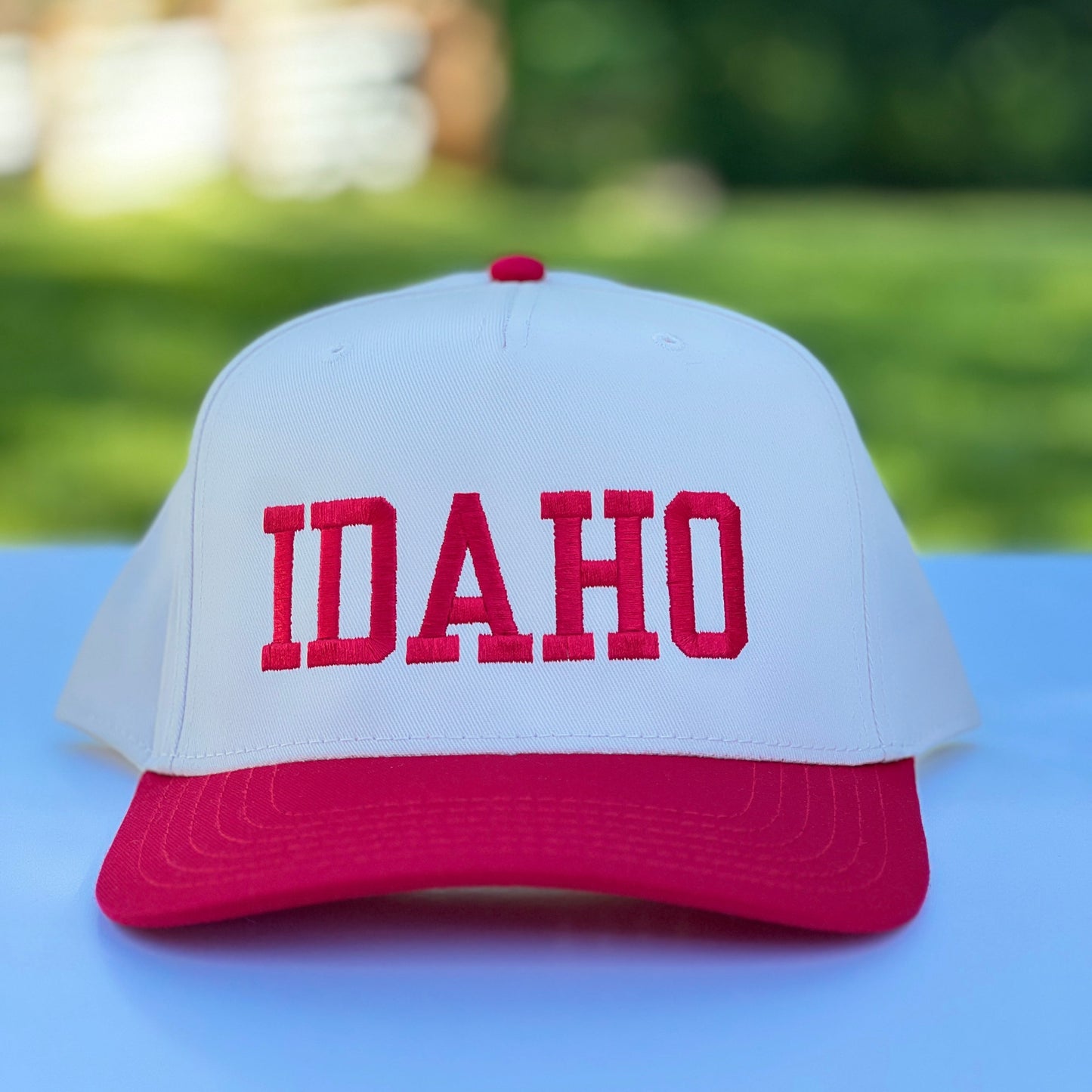 Idaho Hat with Snapback features, featuring the word Idaho on the front and red and on a classic natural and red cap