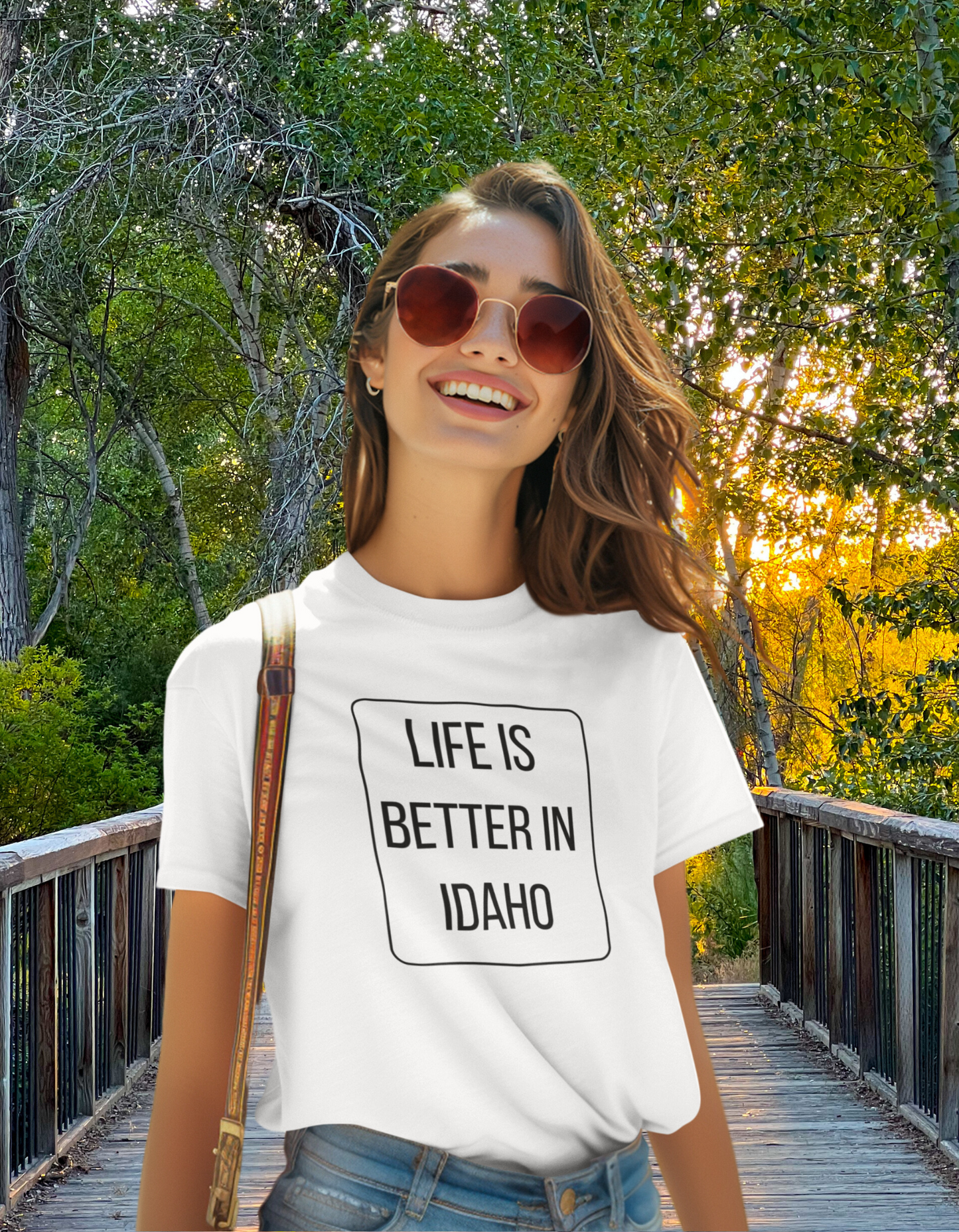 This Idaho T Shirt says Life is Better in Idaho across it, this t shirt comes in white. It proudly states that life is better in Idaho, because it is! The picture shows a women enjoying a walk out on the Boise Greenbelt. Idaho is such a fun place to live and has so many outdoor activities. The Boise Greenbelt being one of them