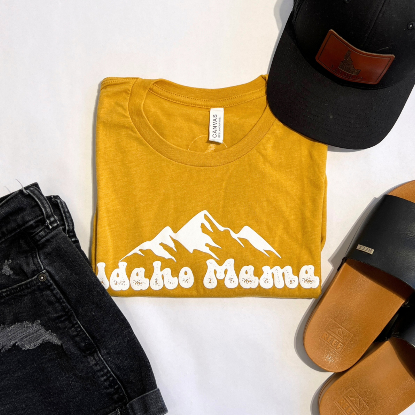 Idaho Mama shirt in Sage green. This cute Idaho Mama shirt is a cute style that can be dressed up or down. This t shirt is designed right here in Idaho by an Idaho Apparel Company. This Idaho T Shirt showcases the adventure an Idaho pride. The letters on the Idaho T shirt say Idaho Mama.