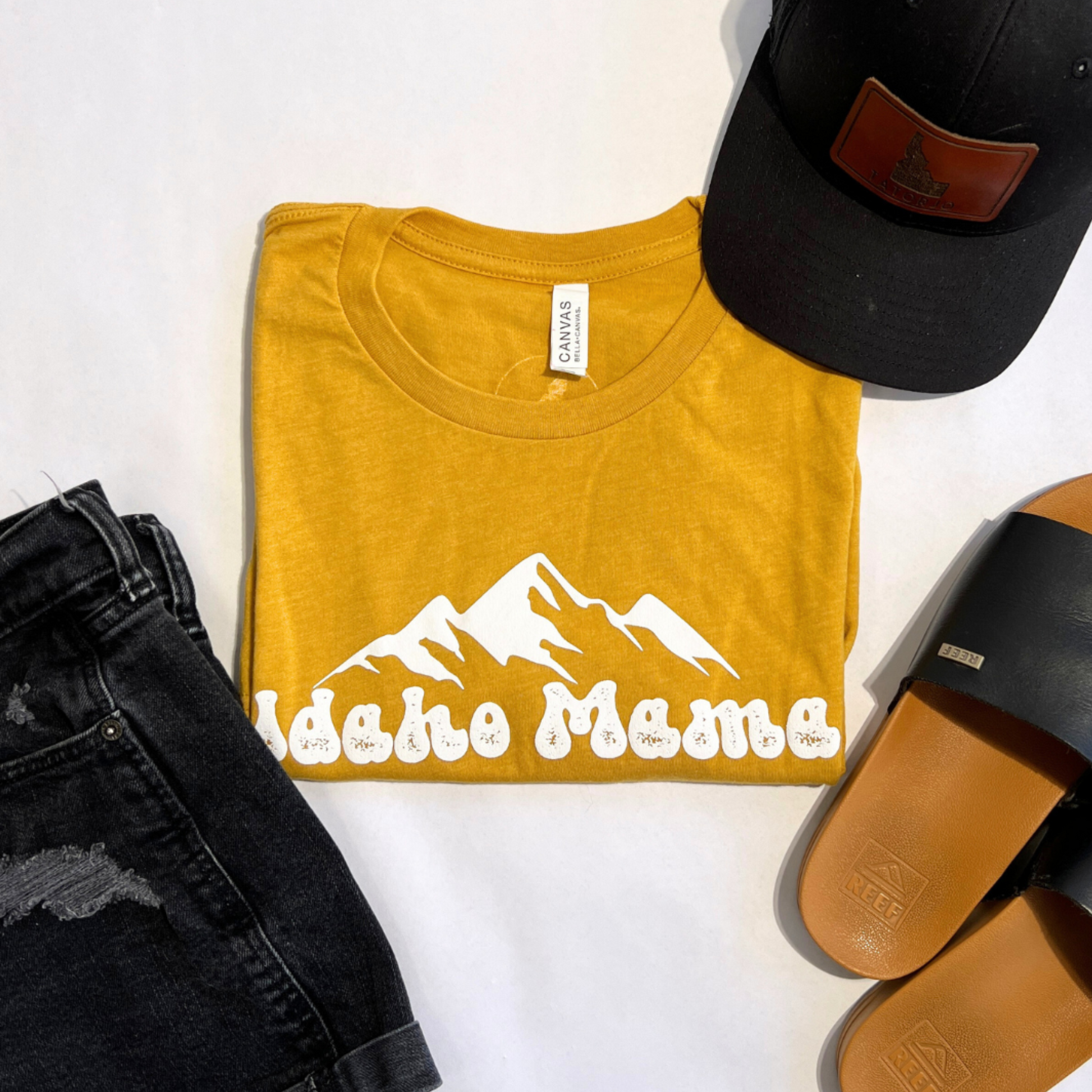 Idaho Mama shirt in Sage green. This cute Idaho Mama shirt is a cute style that can be dressed up or down. This t shirt is designed right here in Idaho by an Idaho Apparel Company. This Idaho T Shirt showcases the adventure an Idaho pride. The letters on the Idaho T shirt say Idaho Mama.