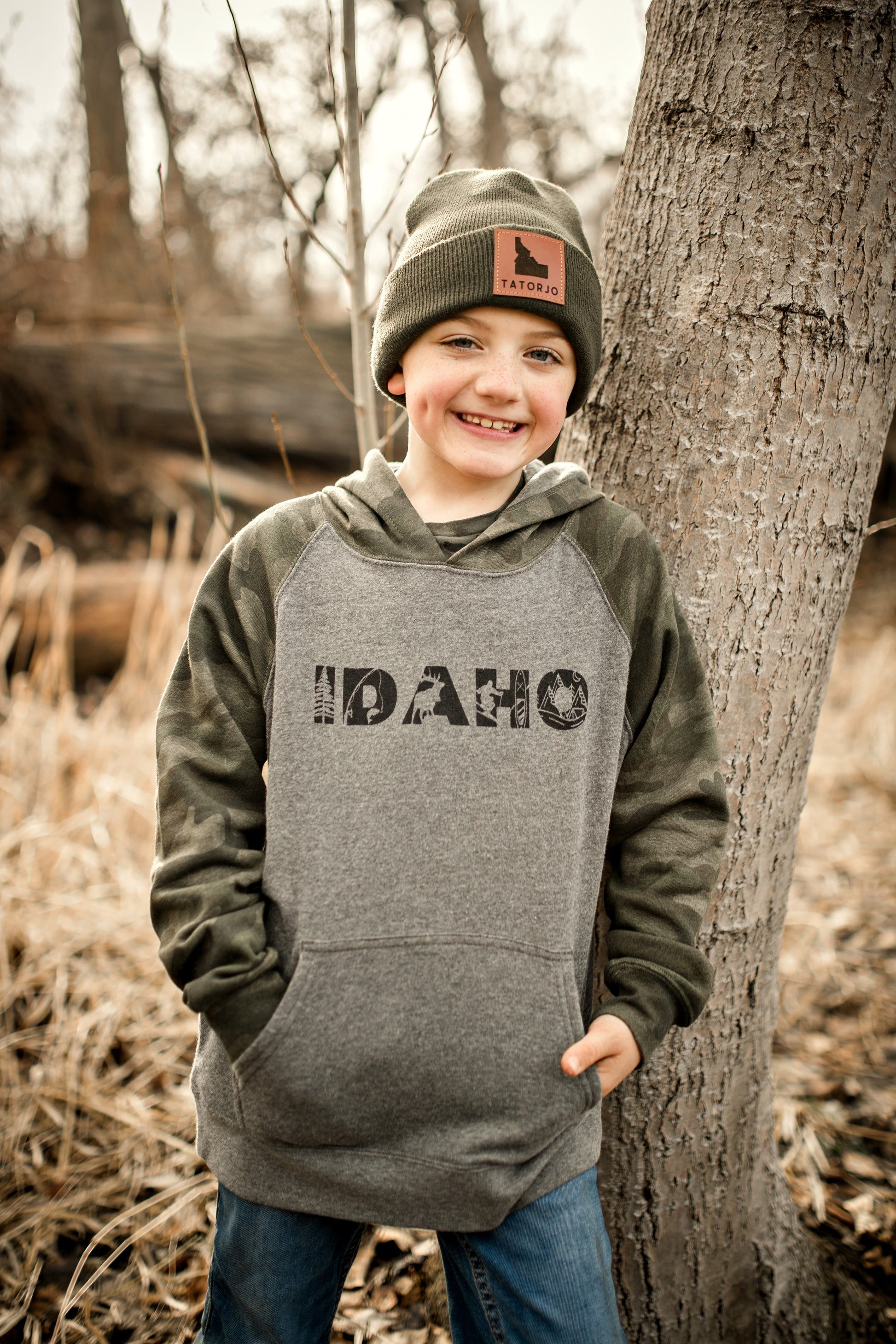 Get ready to embrace Idaho's outdoor vibes with our Adventure Camo Hoodie! This stylish camo design pays homage to the Gem State's rugged beauty and spirit. Perfect for exploring wildlife, camping, and paddle boarding in the mountains. Lightweight and ideal for spring and summer nights. An essential for every adventure-loving Idahoan. Idaho Apparel. Made in Idaho. TatorJo Apparel. Made in Idaho. Idaho sweaters. Idaho hoodies. Idaho gifts. Idaho moving to Idaho.