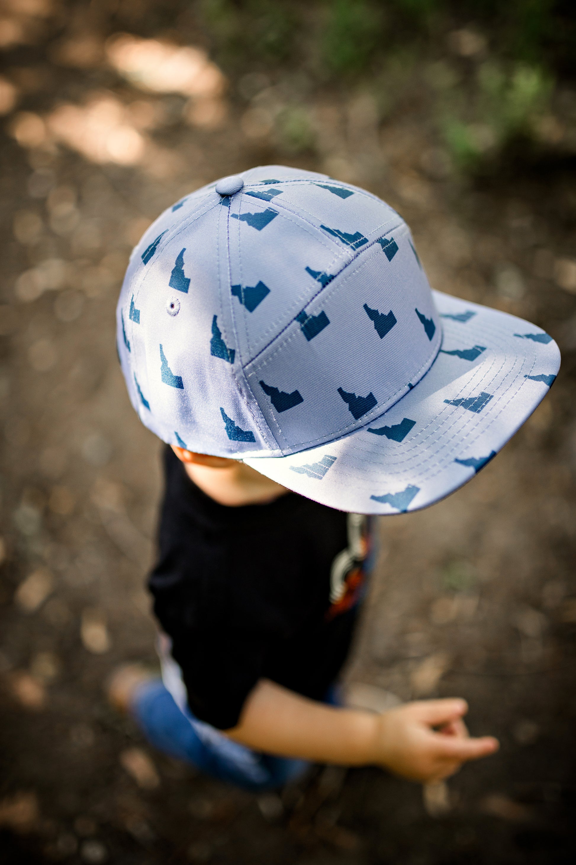 Idaho hat. This little boy wearing an Idaho hat outside in Idaho. 