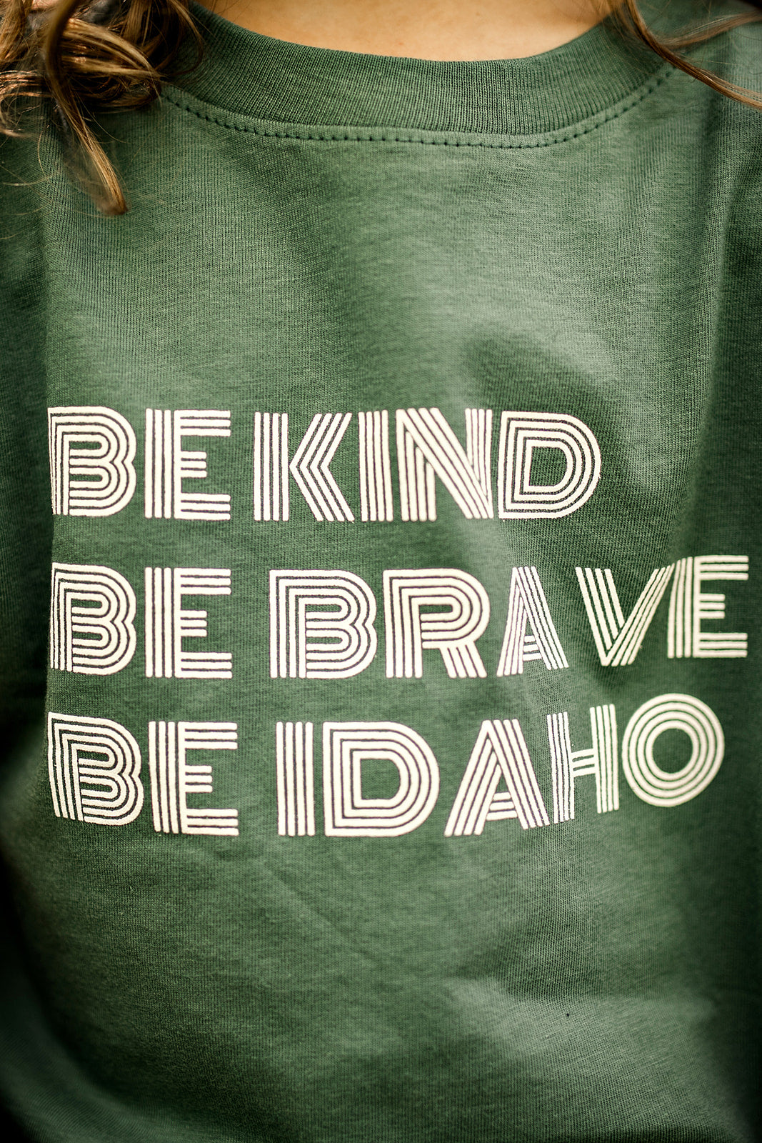 Idaho t Shirts, apparel for Idaho Kids. Apparel for Idahoans. This idaho T shirt says Be Kind, Be Brave, Be Idaho. It's focus is to bring love and kindness to Idaho. 