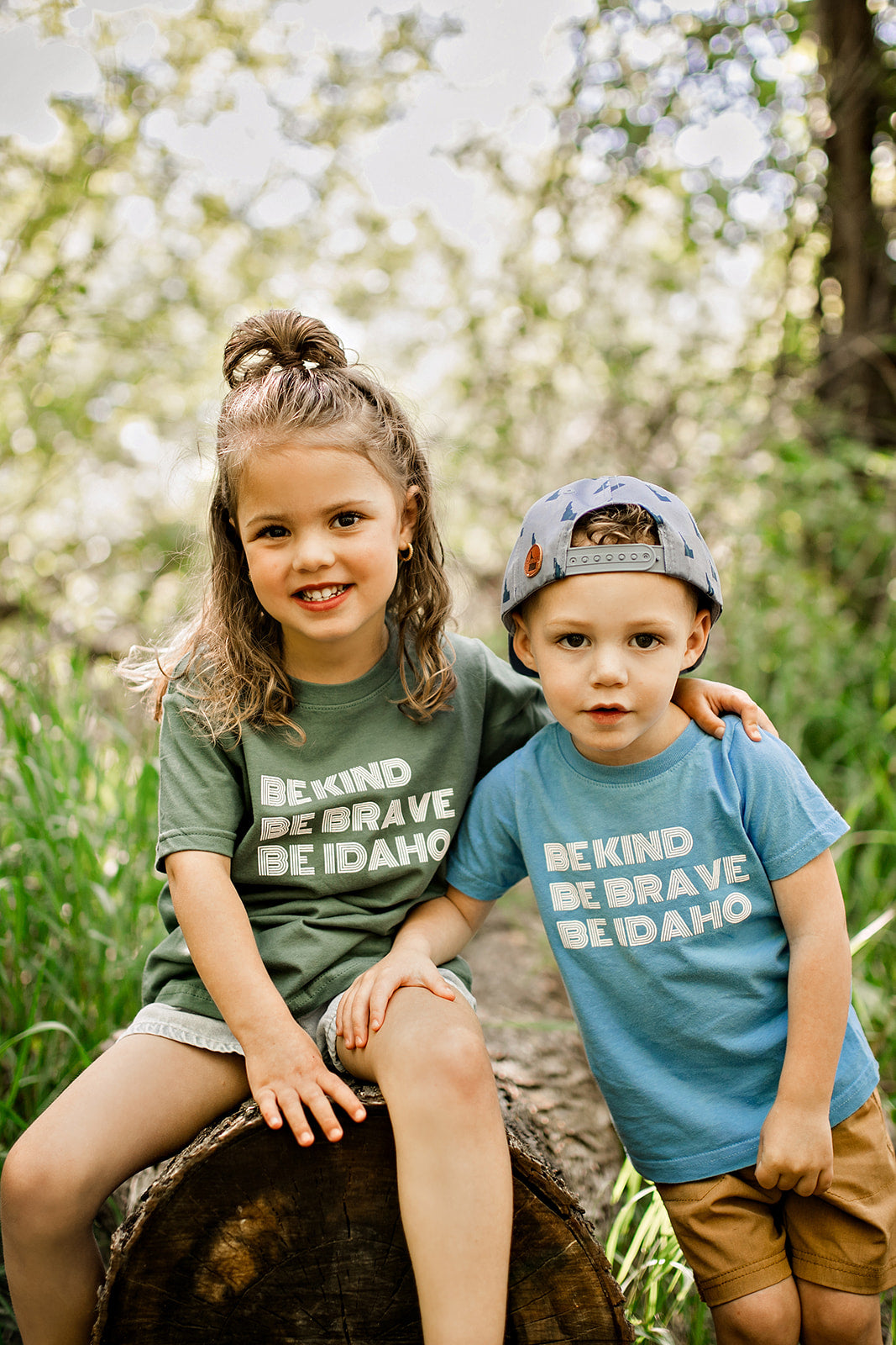 Two Idaho Kids wearing Idaho T shirts, enjoying the outdoors in Idaho. The shirt fits toddlers sizes 2t-5t. The shirt says, Be Kind, Be BRave, Be Idaho