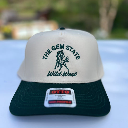 This Idaho Wild West Hat is green and natural colored. This Idaho has has a horse on the front with the words The Gem State, Wild West on it. Designed by TatorJo