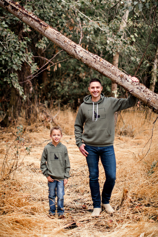 An Idaho dad and young Idaho boy wearing Idaho hoodies. The hoodies are a military green with an Idaho design on them. TatorJO specializes in matching hoodies. The two are stylish!