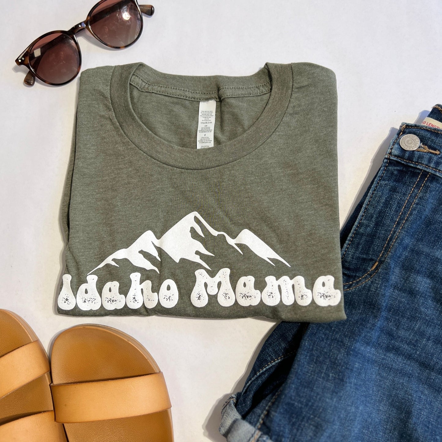 Idaho Mama T Shirt is a must if you live in Idaho. This Idaho T Shirt showcases the Idaho Mountains and has Idaho Mama on the front. Idaho Apparel Clothing Company operated in Idaho.