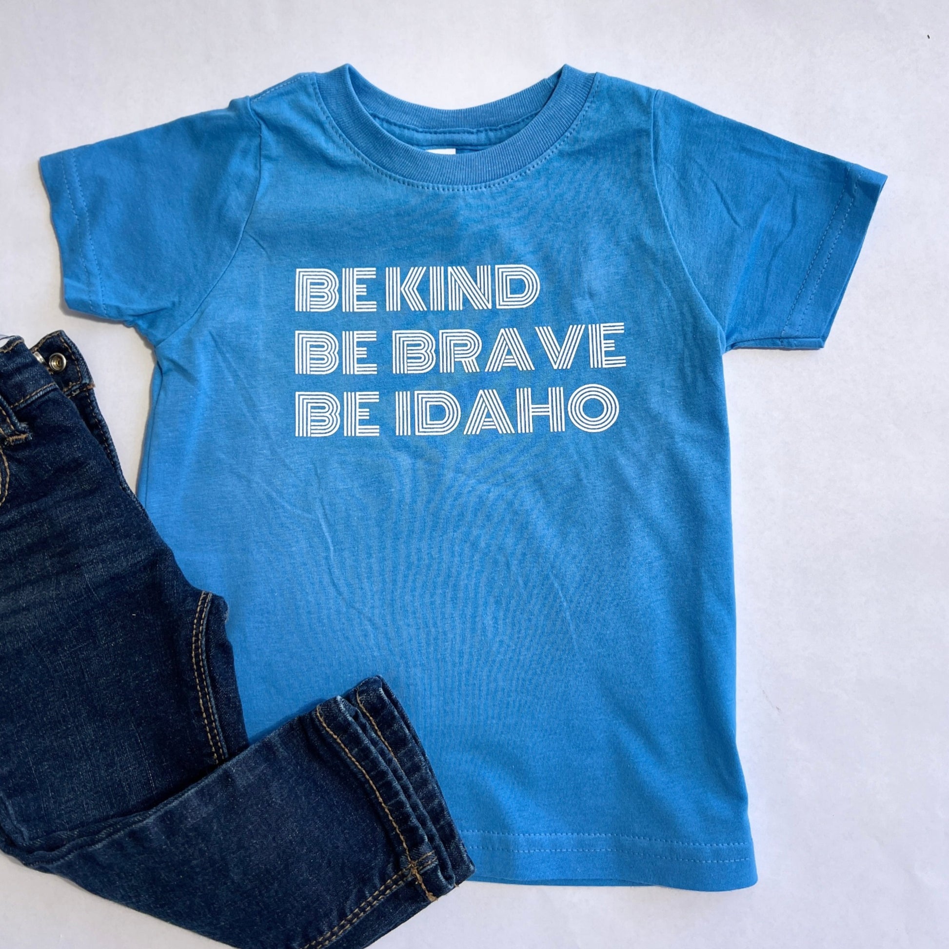 This Idaho T shirt is designed in Idaho. The T Shirt says Be Kind, Be Brave,Be Idaho. This shirt is showcasing the love Idaho has for everyone. All TatorJo apparel is made right here in Idaho.