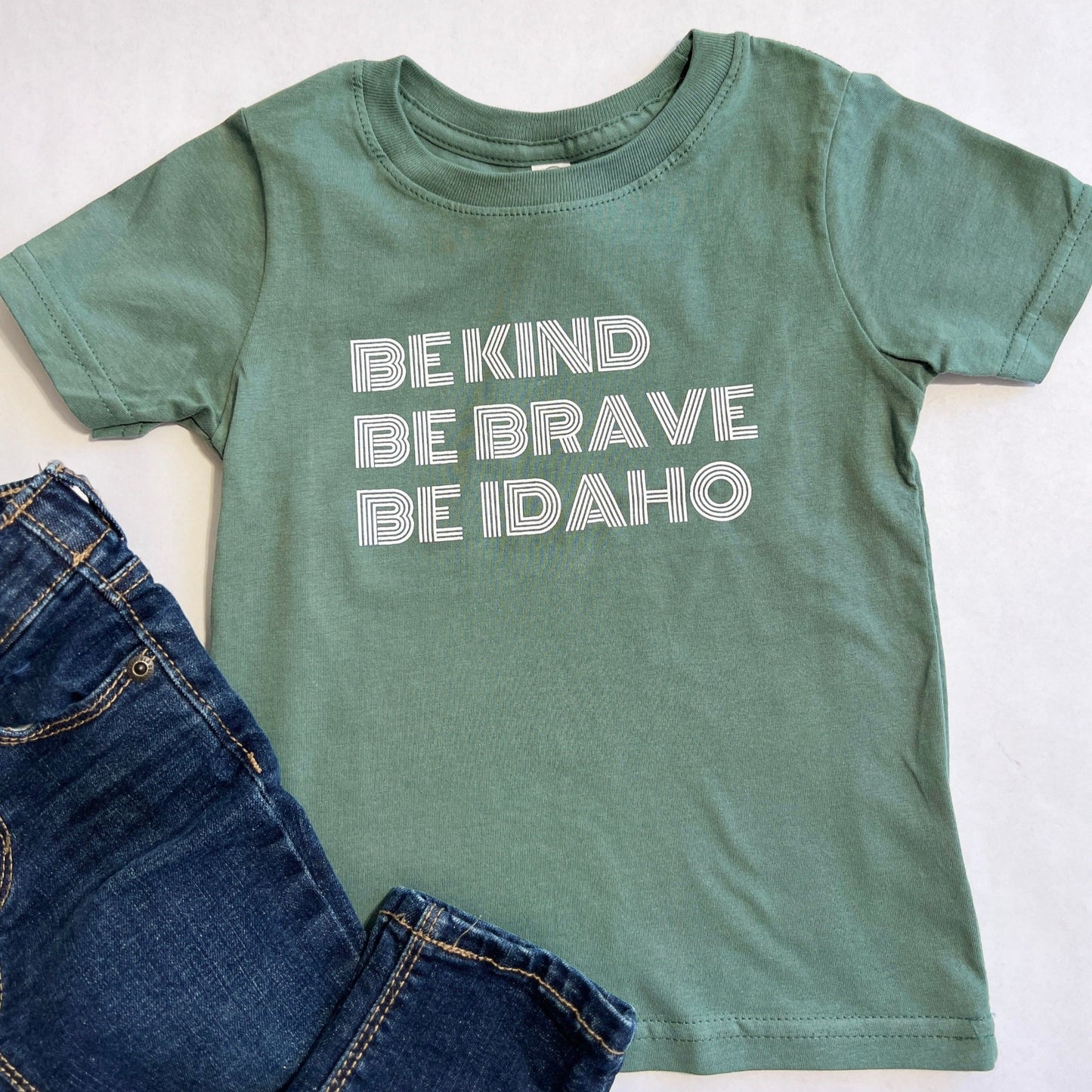 Idaho t Shirts, apparel for Idaho Kids. Apparel for Idahoans. This idaho T shirt says Be Kind, Be Brave, Be Idaho. It's focus is to bring love and kindness to Idaho. 