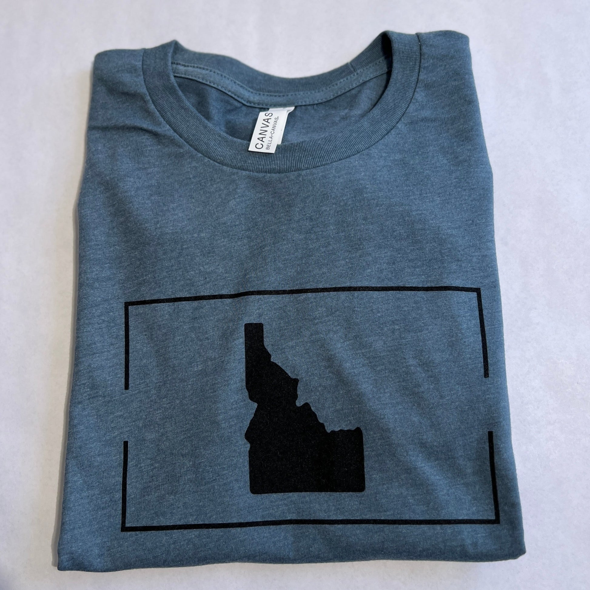 This Idaho Apparel showcases Idaho love and Idaho pride, it has an Idaho printed on the front, simple and classic. This blue is a classic blue that goes with many different outfits. Idaho shirts represent the love you have for Idaho, whether you are visiting Idaho or living in Idaho show your love for Idaho with this Idaho T shirt. All Idaho T shirts are screen printed in Idaho.