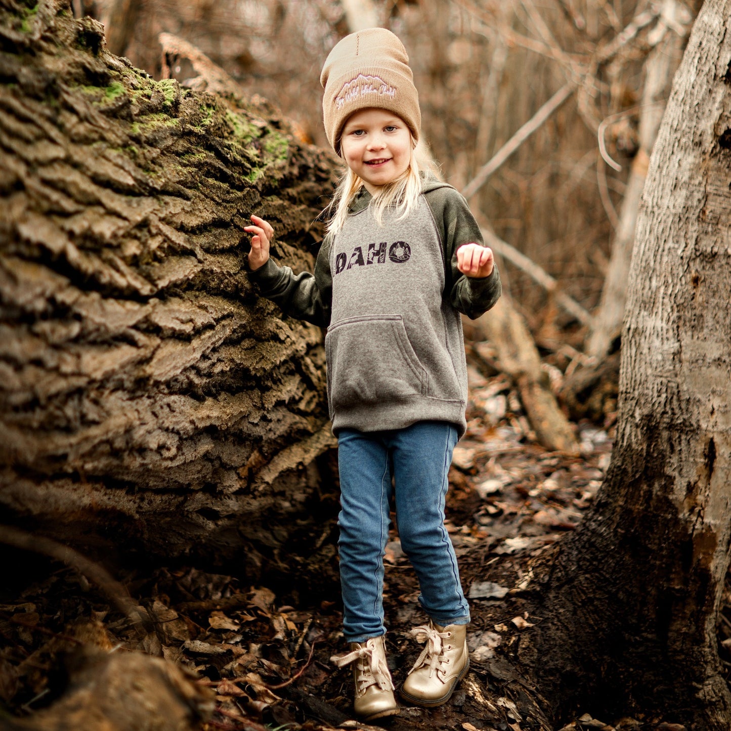 A camouflage hoodie featuring vibrant graphics of Idaho's wildlife, camping scenes, and paddle boarding in the mountains, capturing the essence of outdoor adventure in the Gem State. Idaho Advneture. Idaho Apparel. Idaho sweatshirts. Made in Idaho. Idaho camo hoodies. Idaho adventures. Idaho apparel. Apparel for Idaho kids.