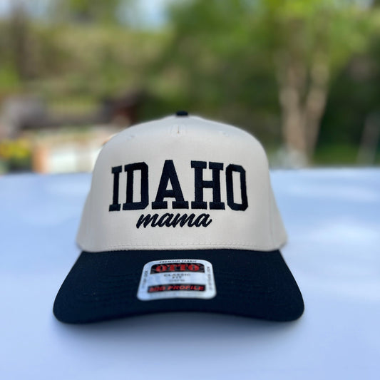Cream and black trucker-style Idaho Mama Hat with bold embroidered lettering, designed by TatorJo; adjustable snapback cap perfect for summer sun and Idaho moms.