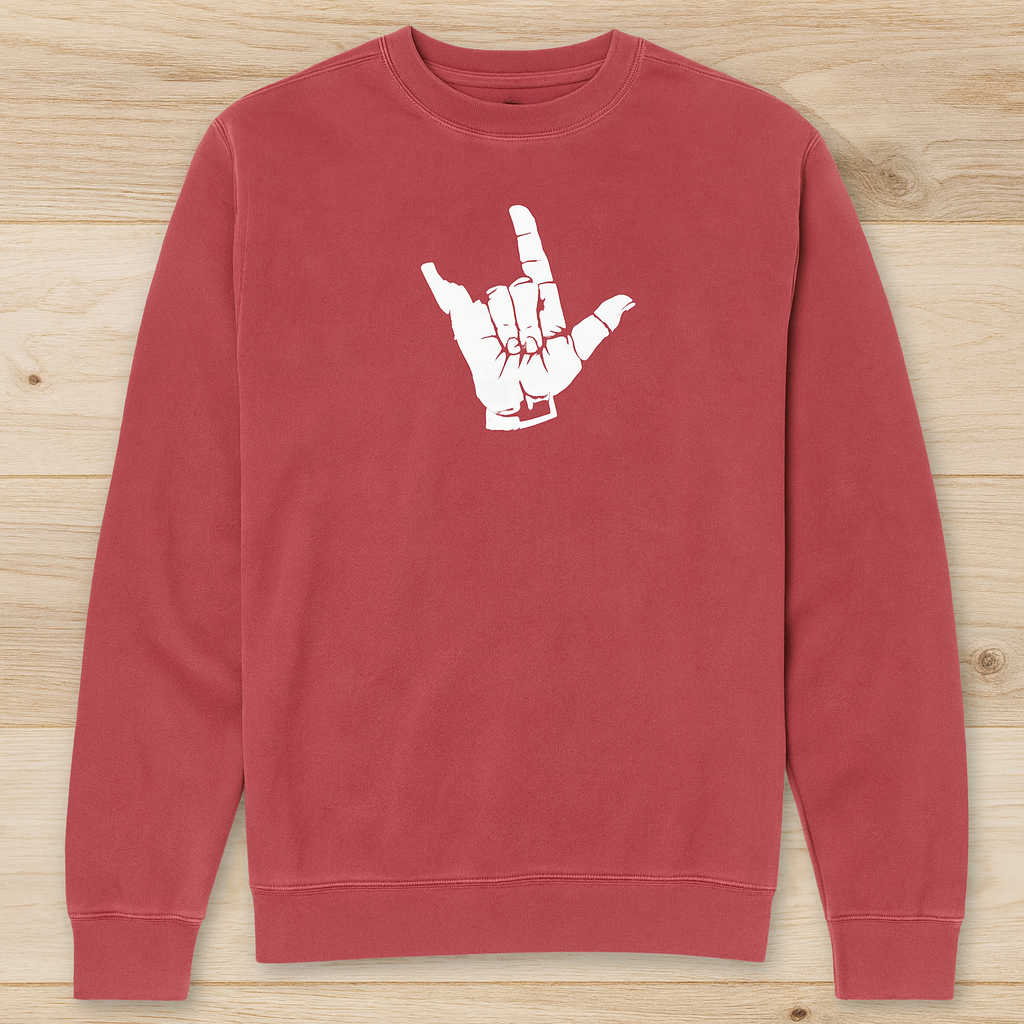 Red Idaho sweatshirt with a white hand gesture design on a wooden surface