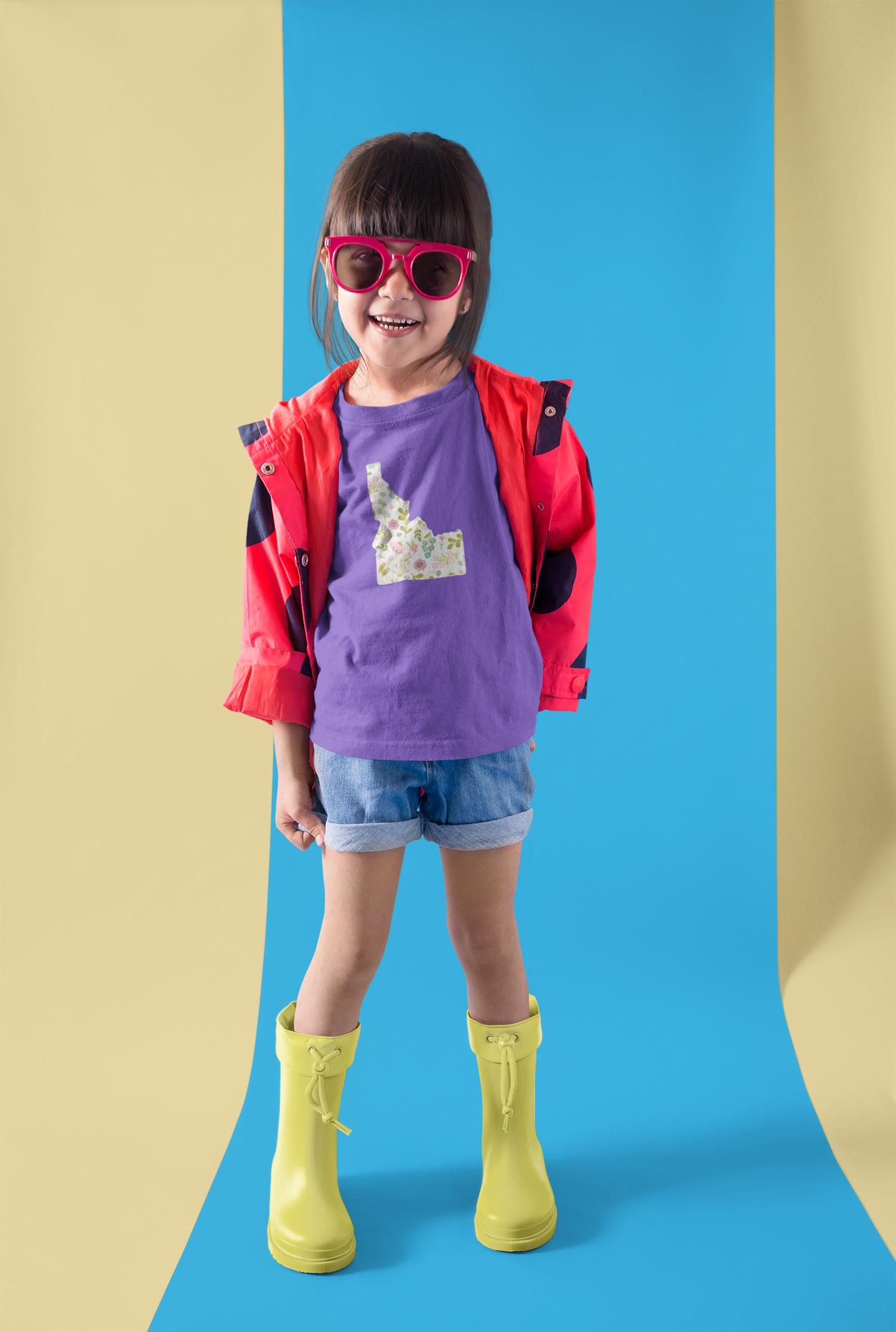 Little guy wearing a a purple t shirt that has an Idaho design on it. THe idaho design is floral, super cute! Little girl is stylish in her Idaho swag